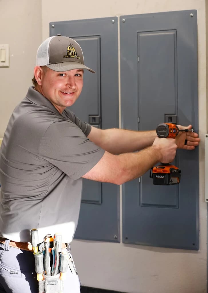A licensed Buzz Electrical technician working on a home electrical panel